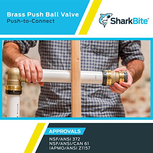 Brass ball valve with push-to-connect fittings being held by hands on either end, connected to white PVC pipe.