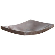 Antique copper vessel sink with curved sides and hammered surface texture.