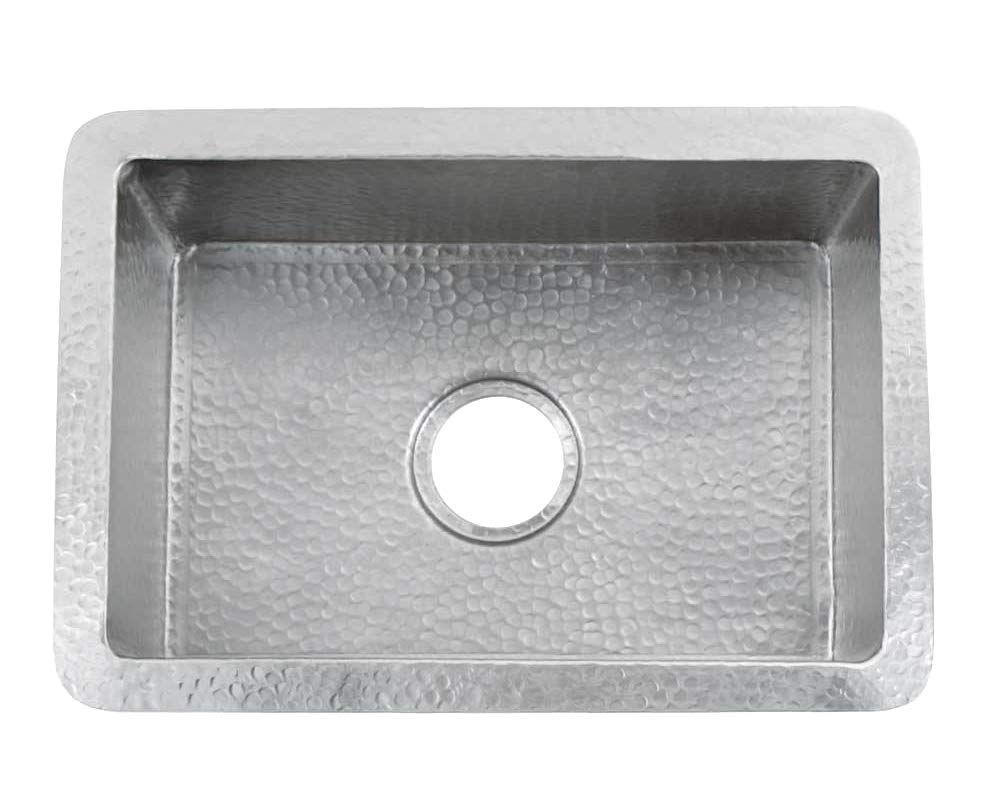 Brushed nickel single-basin undermount kitchen sink with hammered interior texture and drain opening.