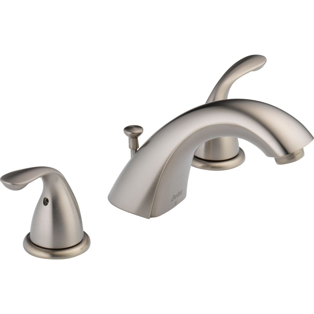 Brushed nickel widespread bathroom faucet with two handles, curved spout, and pop-up drain assembly.