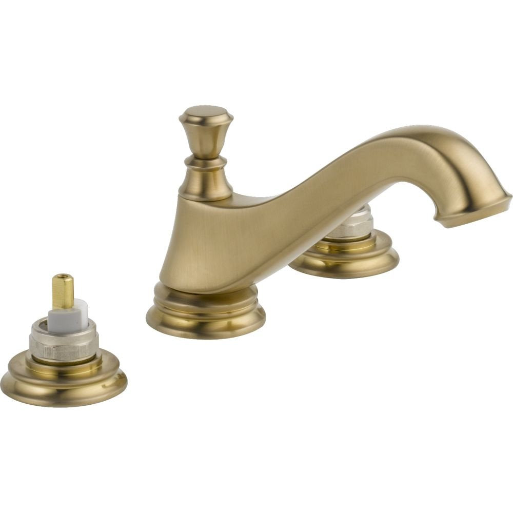 Champagne bronze two-handle bathroom faucet with low arc spout and separate pop-up drain assembly.