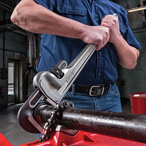 RIDGID 24 inch aluminum straight pipe wrench held in use gripping a dark metal pipe.
