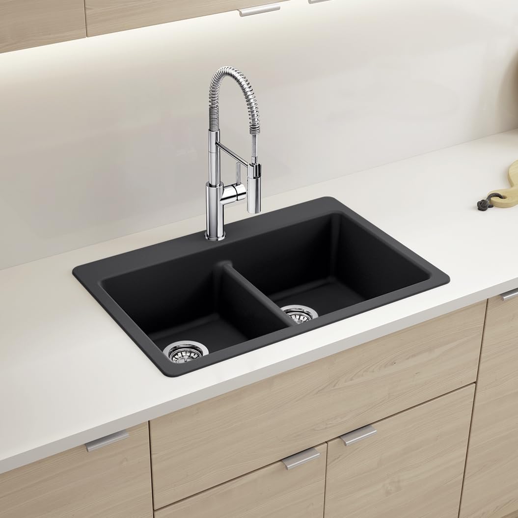 Coal black double bowl drop-in sink with low divide and chrome pull-down faucet in kitchen countertop.