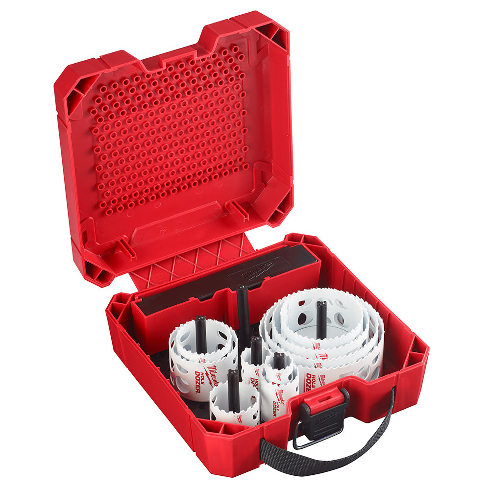 Red plastic case containing white hole saws of varying sizes with black arbors and a red handle.