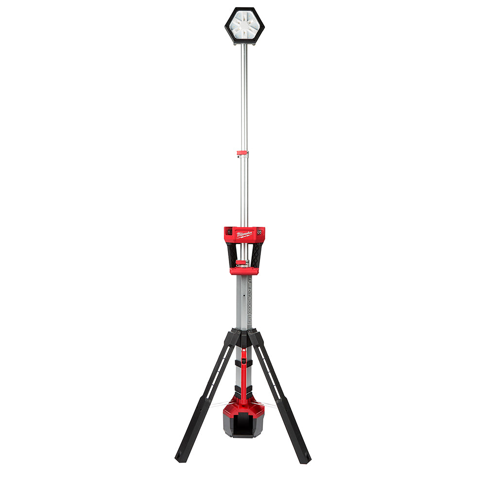 Tall tower light with hexagonal LED head on telescoping pole, red body with black tripod base and hanging work light.