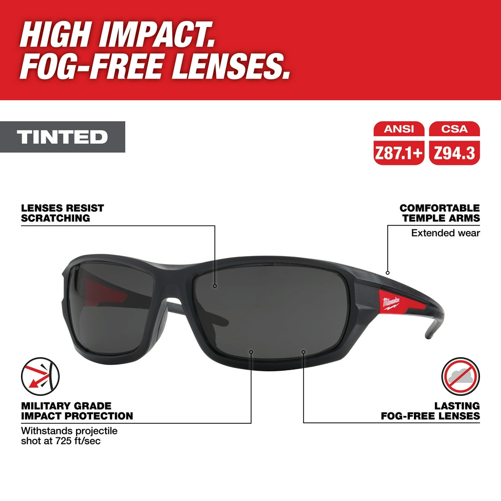 Black safety glasses with tinted lenses, red accents on temples, and curved wraparound frame design.
