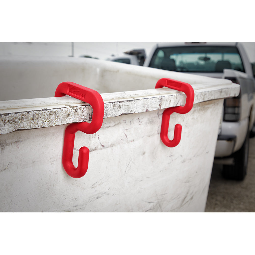 Two red bucket hooks mounted on the rim of a white bucket.