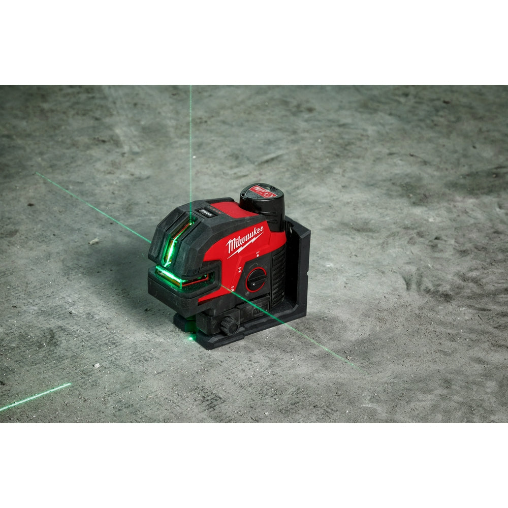 Milwaukee M12 green laser level projecting cross line and four point patterns on concrete floor.