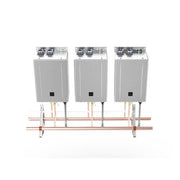Three stainless steel wall-mounted water heater units connected by copper manifold piping with brass valves.