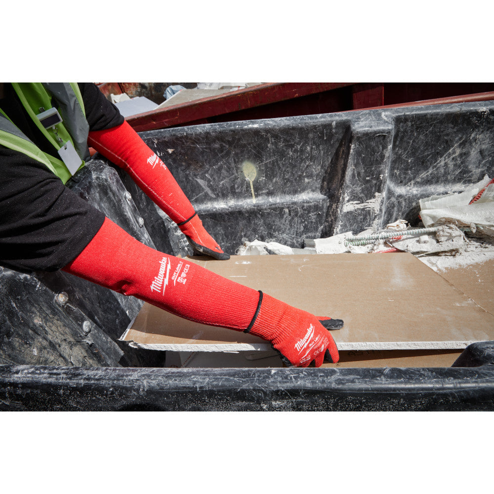 Red protective sleeves worn on arms during material handling and cutting work.