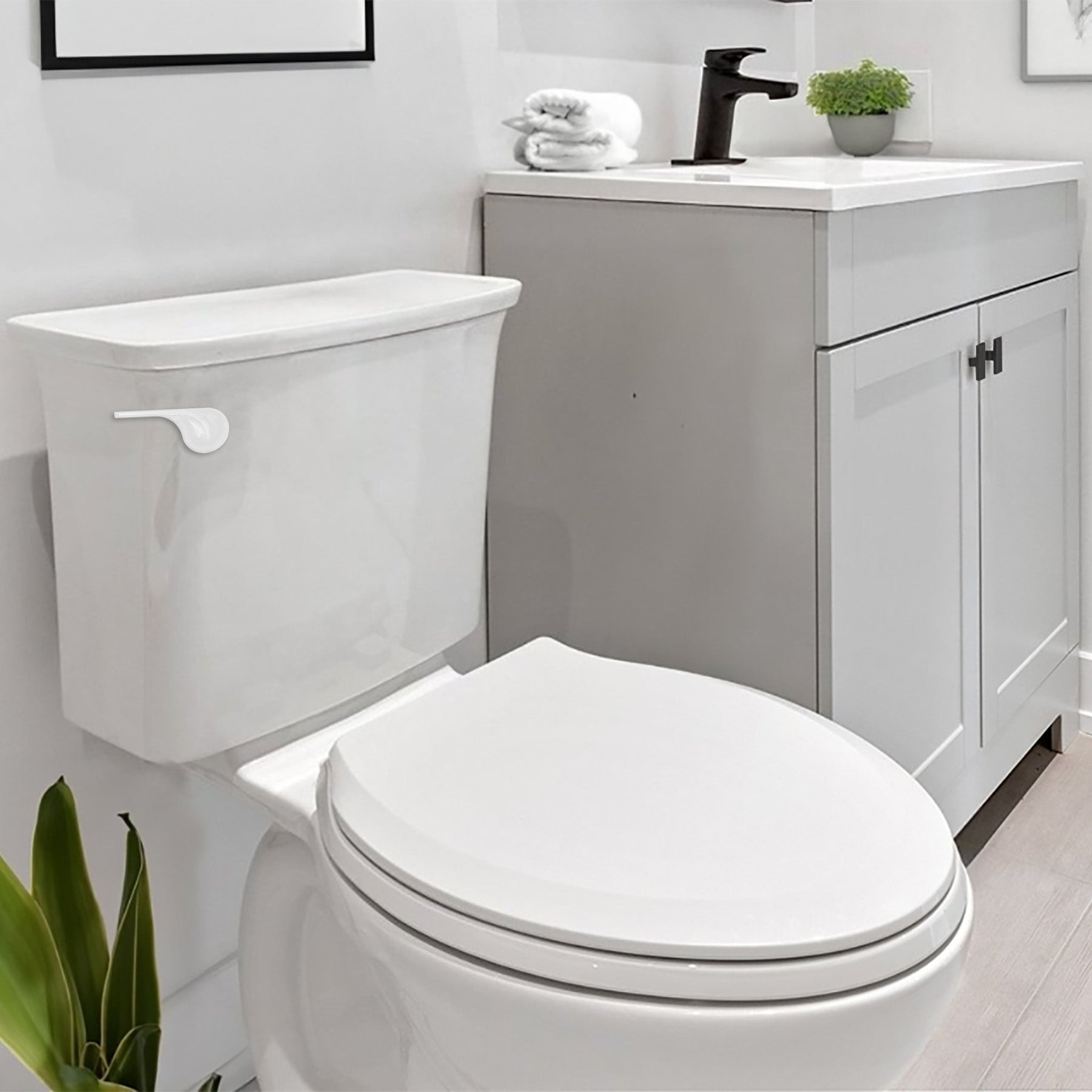 White toilet handle lever mounted on side of white porcelain tank in bathroom setting.