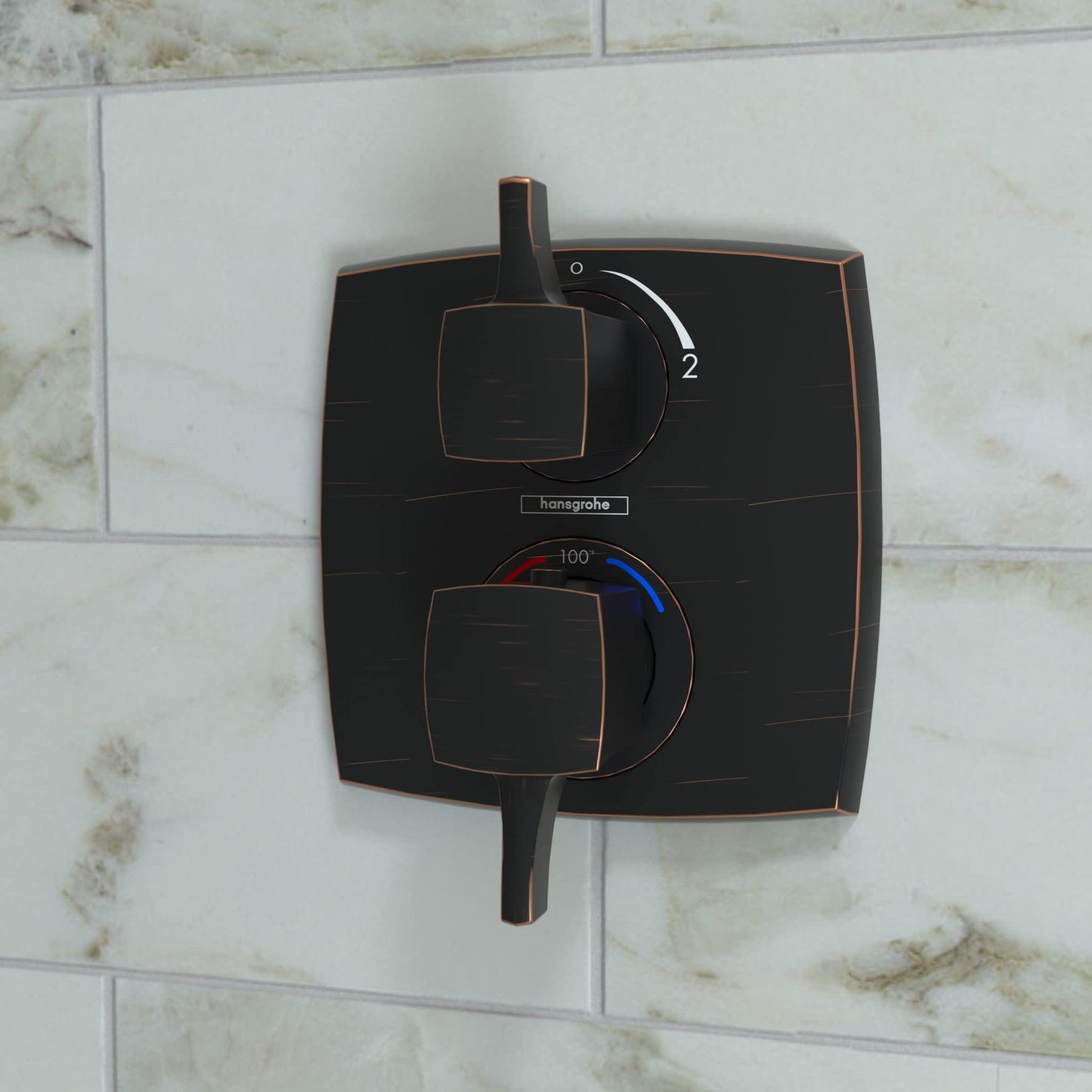 Rubbed bronze square thermostatic shower trim with upper volume control lever and lower temperature dial mounted on tile wall