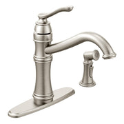 Stainless steel kitchen faucet with high arc spout, single handle, side spray, and deck plate base.