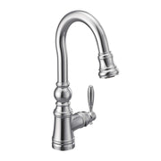 Chrome pulldown kitchen faucet with curved spout, decorative base, and single lever handle.