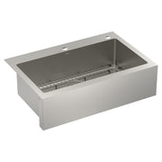 Stainless steel apron front kitchen sink with single bowl, metal grid insert, and two faucet holes.