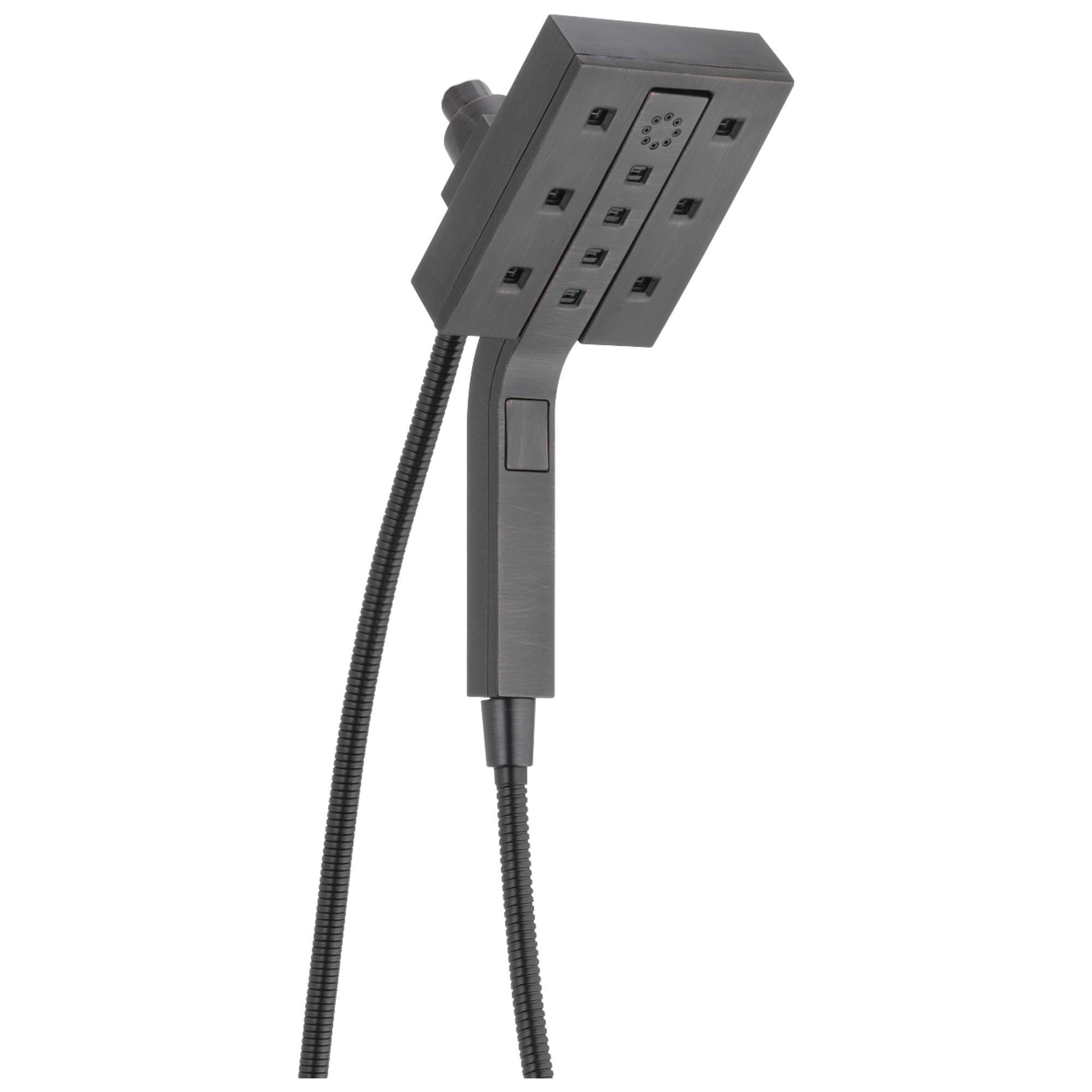 Square dark gray shower head with multiple jets and handheld spray attachment connected by black hose.
