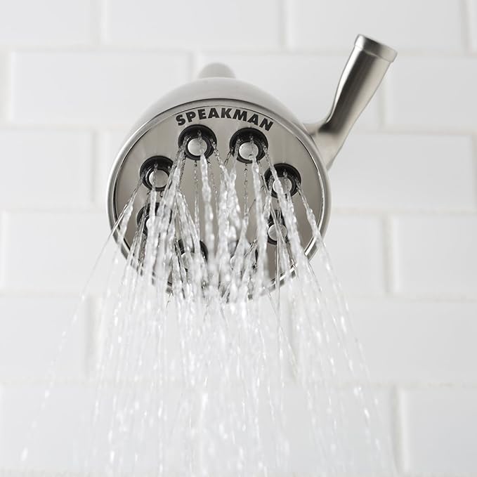 Brushed nickel shower head with four adjustable spray nozzles and angled arm against white tile background.
