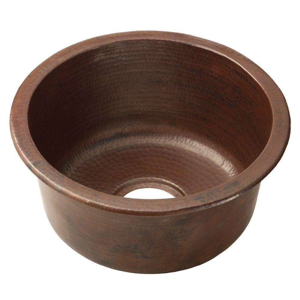 Hammered copper round bar sink with dark patina finish and single drain opening.