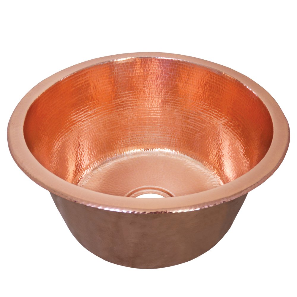 Polished copper round bar sink with hammered interior finish and single drain hole.