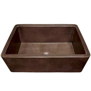 Antique copper farmhouse sink with single basin and textured hammered surface finish.