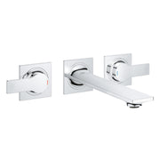 Chrome wall-mounted faucet with two lever handles and spout with square escutcheons.