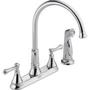 Chrome two-handle kitchen faucet with high arc spout, detachable spray head, and lever handles on deck plate base.
