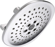 Chrome and white raincan shower head with multiple spray holes and centered dial control for spray settings.