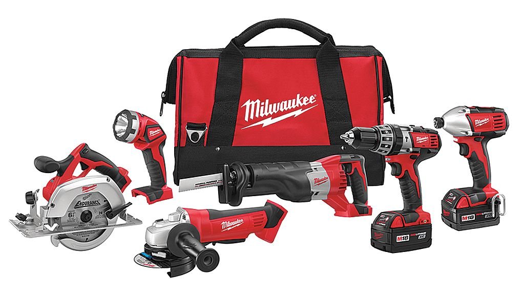 Red and black Milwaukee M18 cordless tool kit with six tools, two batteries, charger, and carrying bag displayed against whit