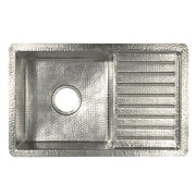 Hammered copper undermount sink with two compartments: larger basin on left and smaller drainboard on right with horizontal r