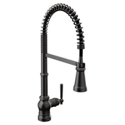 Matte black kitchen faucet with single handle, coiled pulldown sprayer hose, and tapered spout.