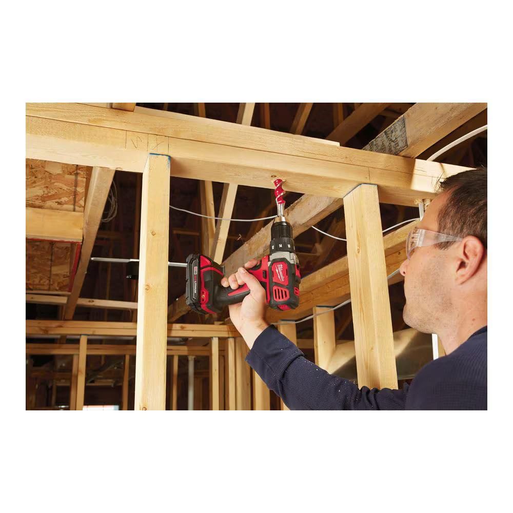 Milwaukee M18 1/2 inch drill driver with red and black body being used to drill into wooden beam framing.