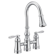 Chrome bridge kitchen faucet with two lever handles and pull-down spout.