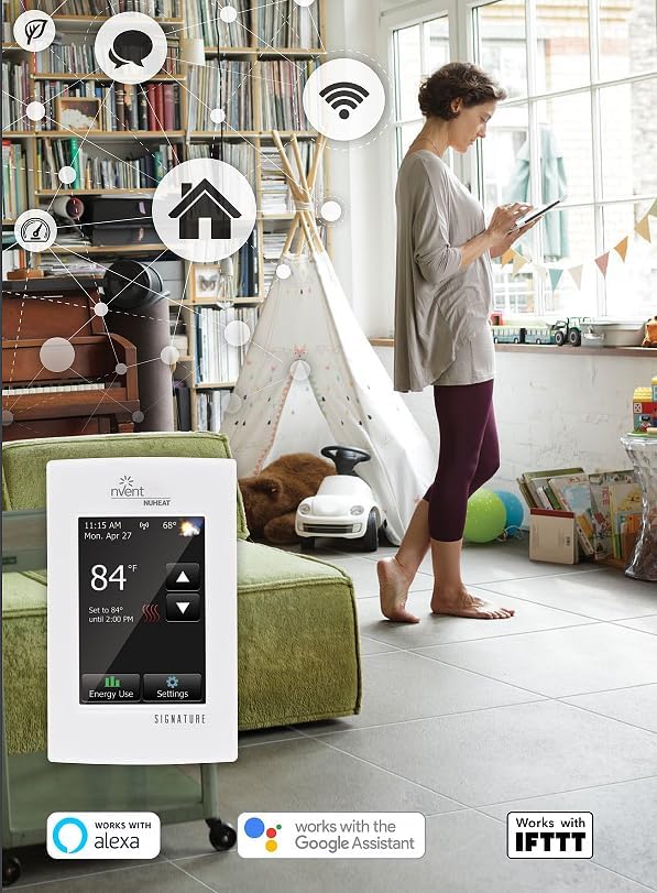 White Nuheat Signature thermostat with touchscreen displaying temperature and settings, shown on wall in modern living room.