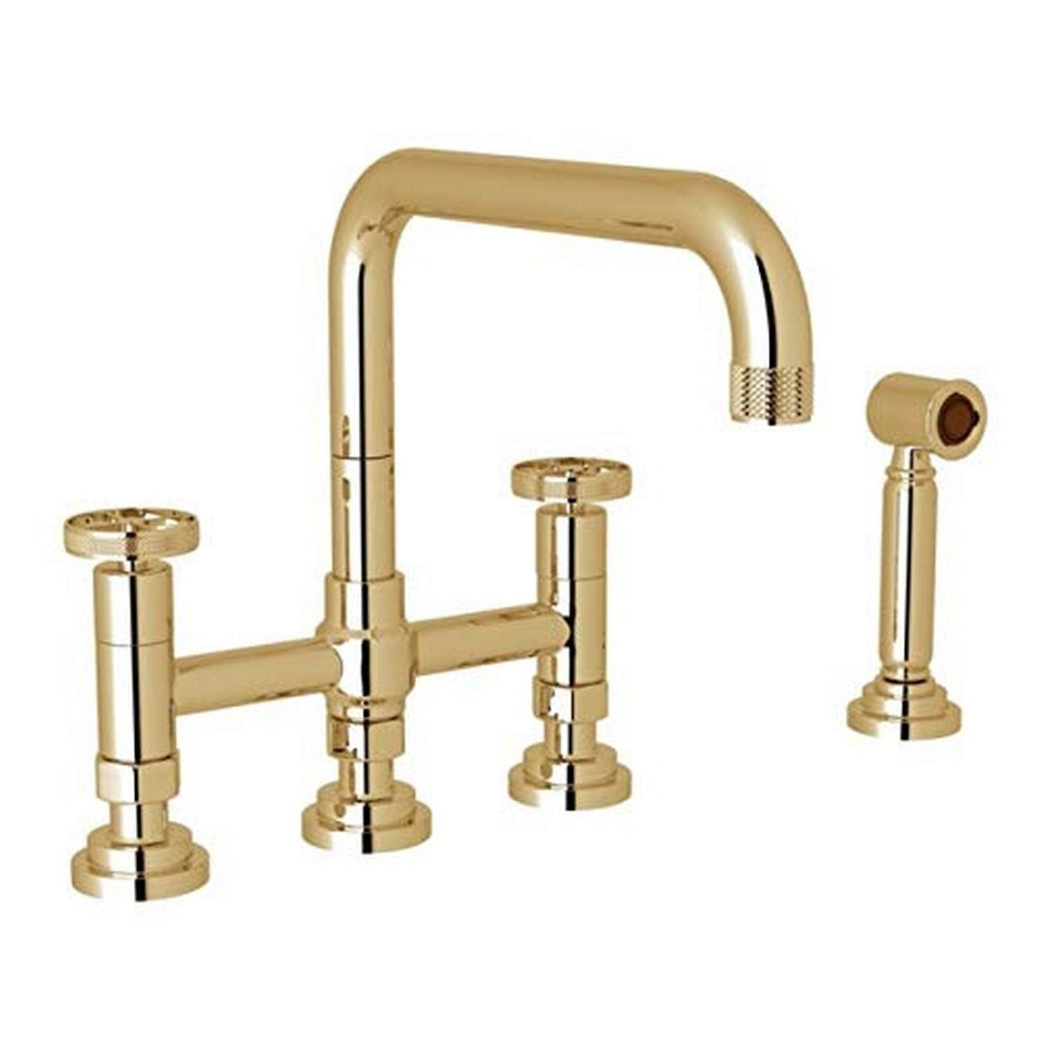 Unlacquered brass bridge kitchen faucet with tall arched spout, two lever handles, and detachable side spray.