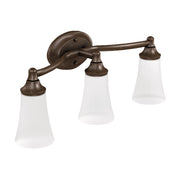 Three-light bathroom vanity fixture with oil-rubbed bronze arms and frosted glass shades.