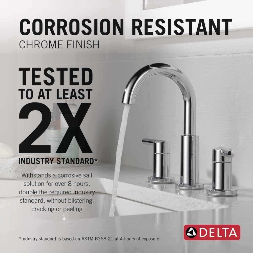 Chrome two-handle widespread bathroom faucet with curved spout and lever handles on white sink countertop.