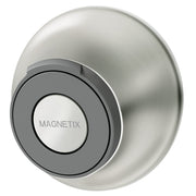 Brushed nickel magnetic cradle with circular opening holding gray and white Magnetix remote control.