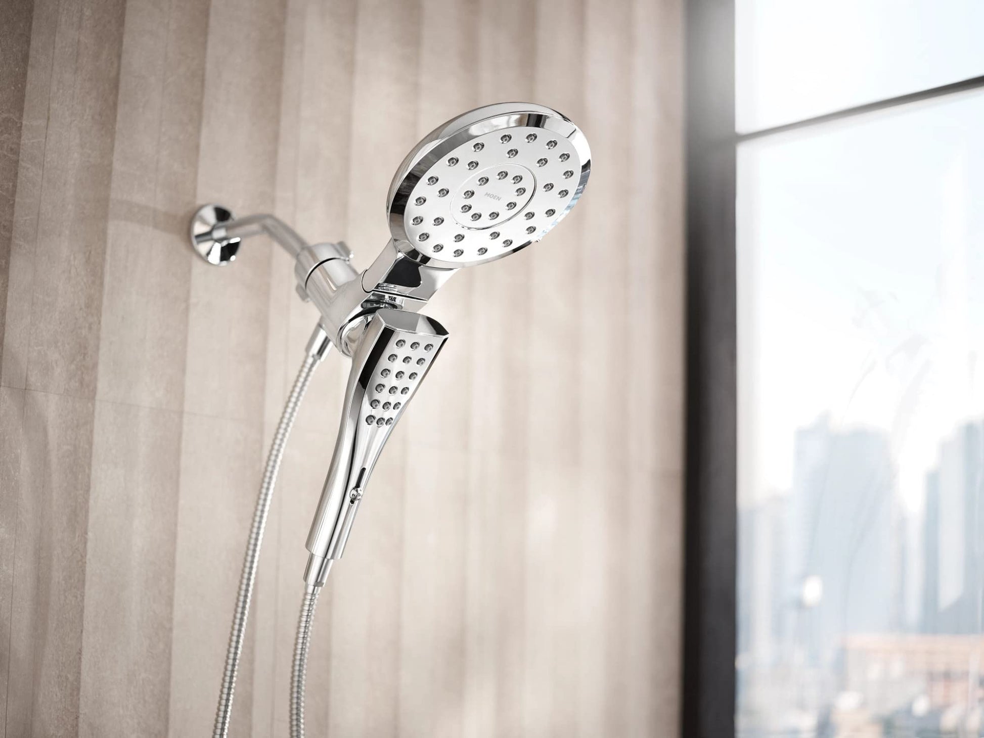 Chrome showerhead with eight spray functions and handheld wand connected by flexible hose mounted on bathroom wall.