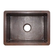 Antique copper kitchen sink with hammered texture finish and single drain hole, viewed from above.