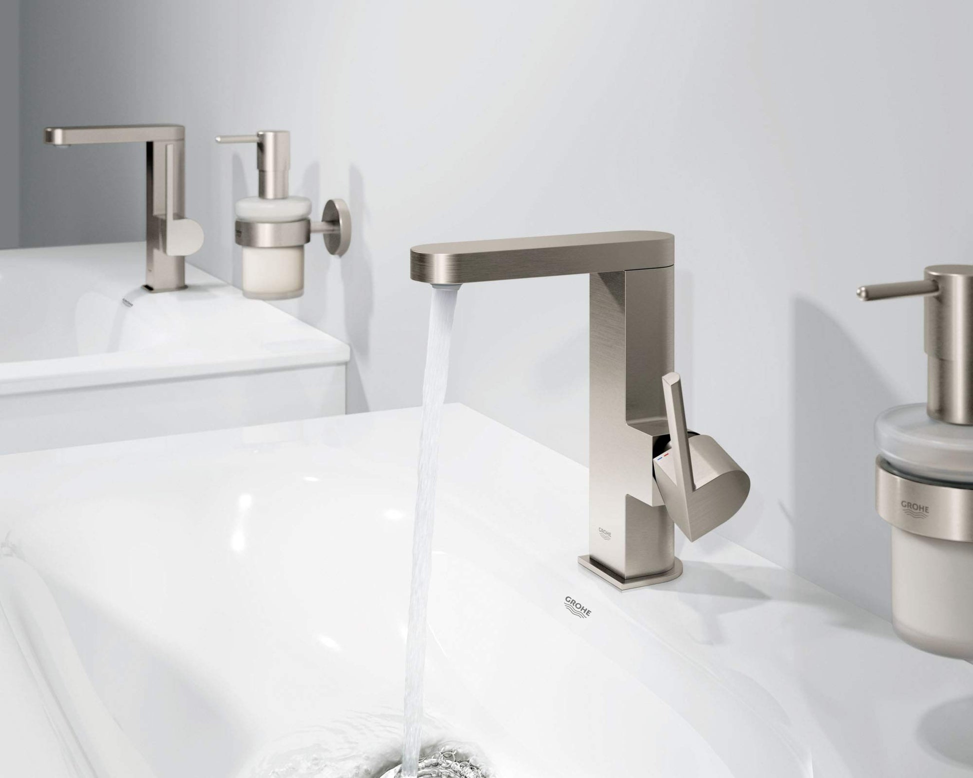 Brushed nickel single-handle bathroom faucet with angular spout installed on white sink counter with water flowing.