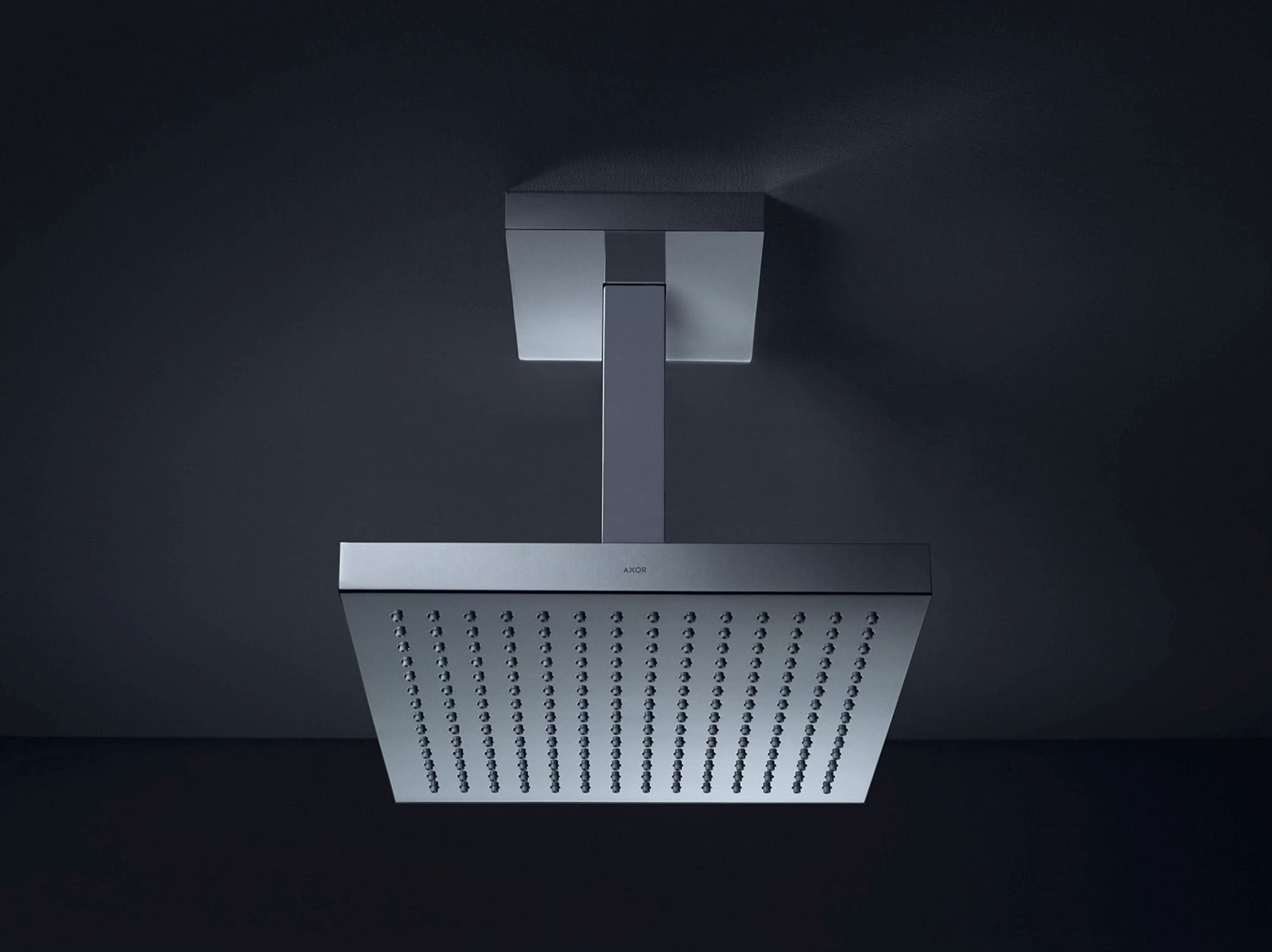 Chrome square shower head with ceiling-mounted arm and perforated spray face.