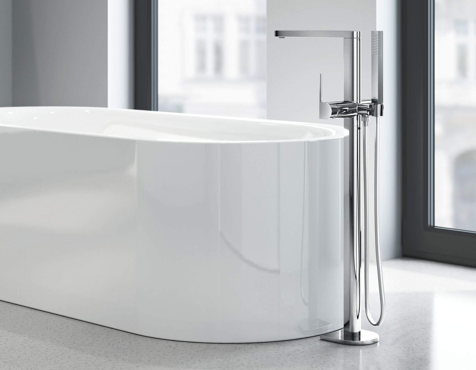 Chrome single-handle freestanding tub faucet with hand shower and curved spout.
