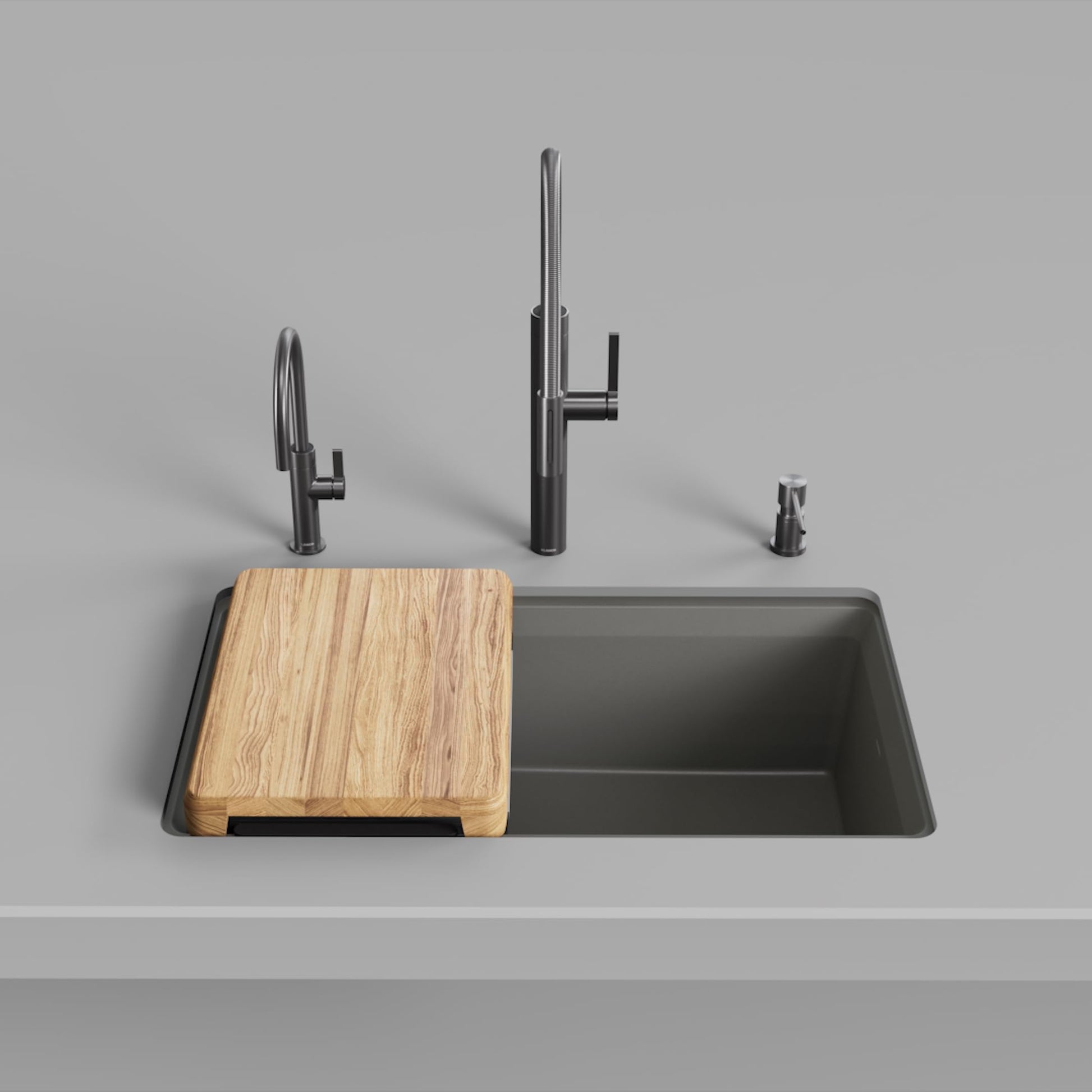 Volcano gray rectangular kitchen sink with wood cutting board, black faucet, and spray accessory displayed from above.