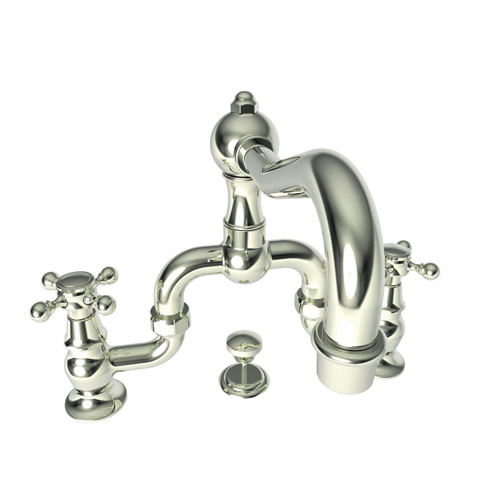 Polished nickel bridge faucet with curved spout, two cross handles, and dome cap, shown with separate drain plug.