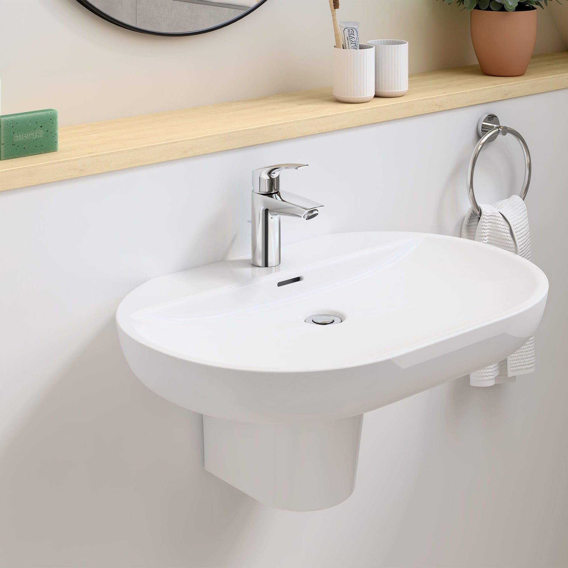 Chrome single-handle bathroom faucet with curved spout mounted on white oval sink.