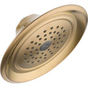 Champagne bronze raincan shower head with multiple spray jets and Delta branding on face.