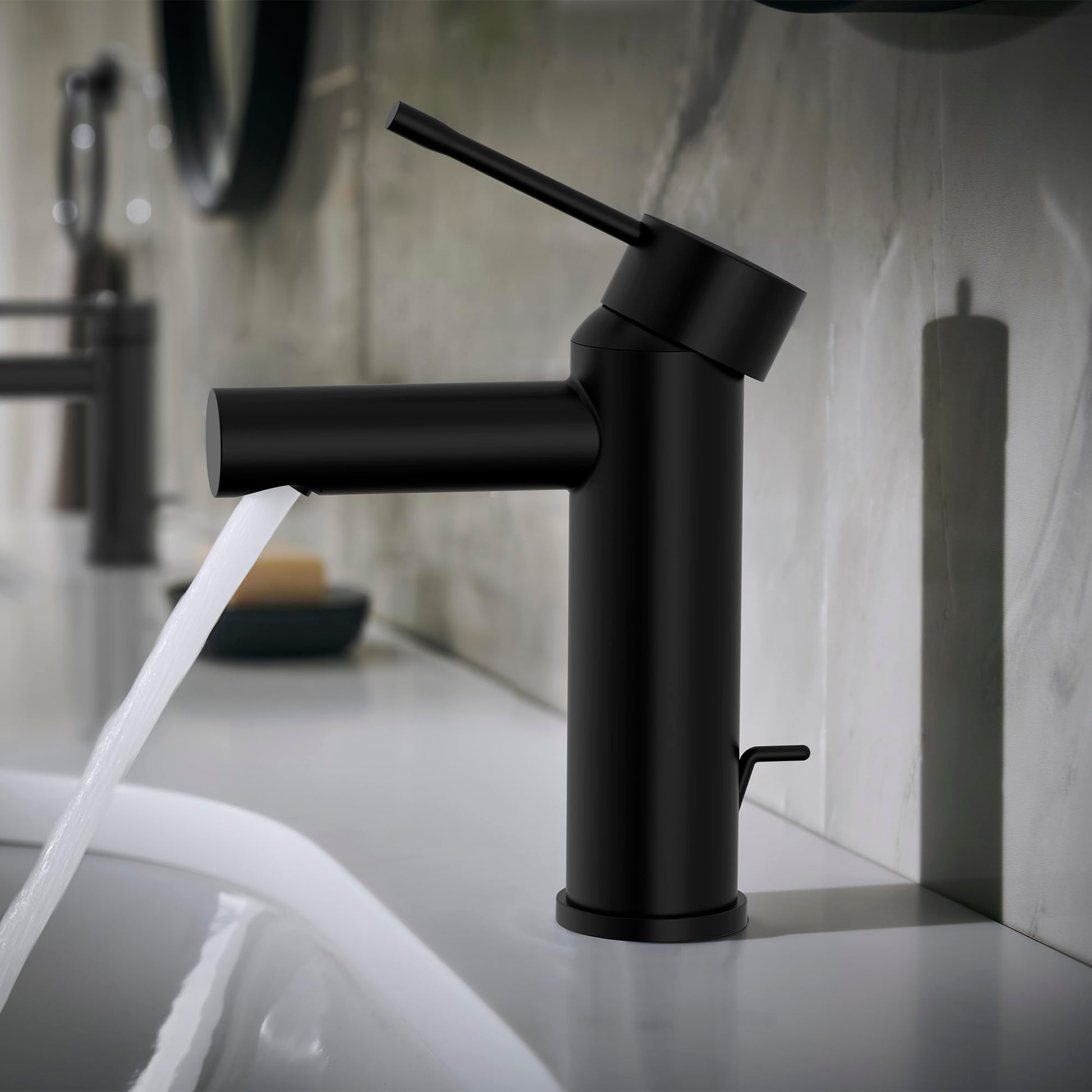 Matte black single-handle bathroom faucet with angled spout and lever handle mounted on white sink basin.