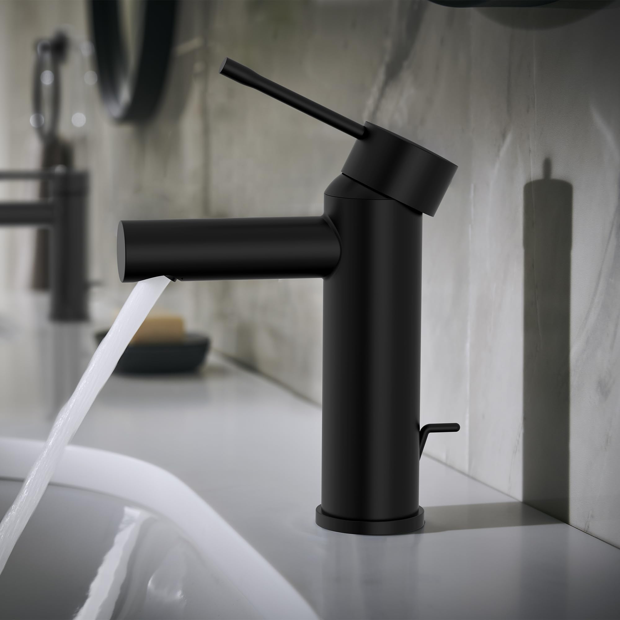 Matte black single-handle bathroom faucet with angled spout and lever handle mounted on white sink basin.