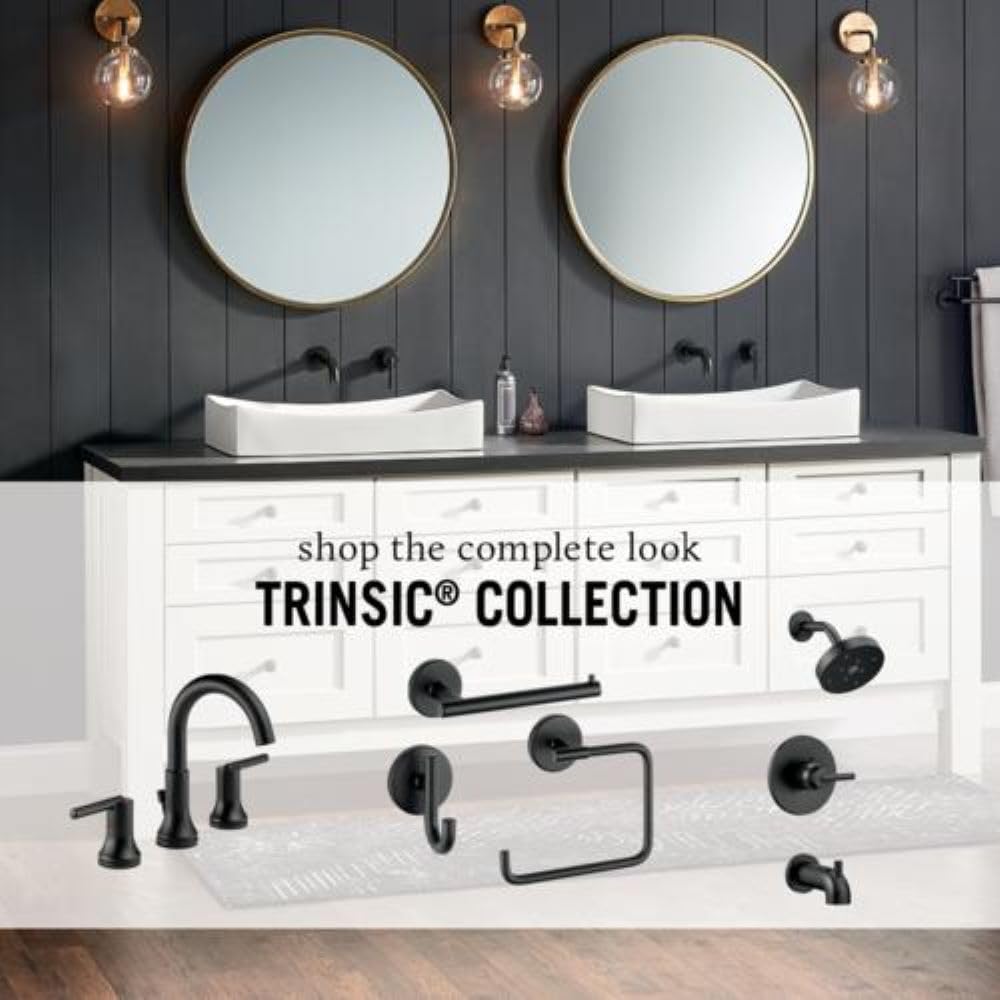 Chrome two-handle widespread bathroom faucet with curved spout and round handles mounted on sink deck.