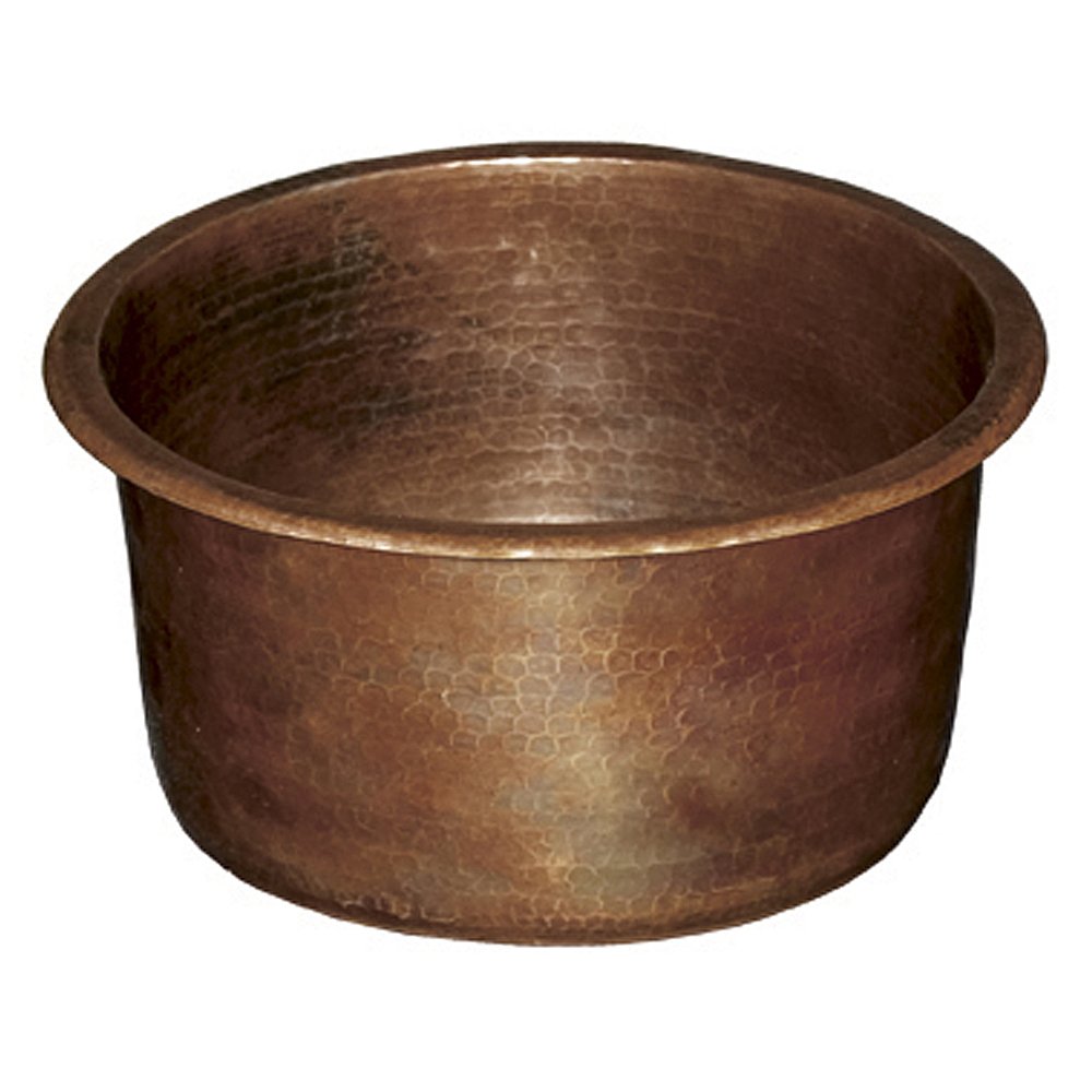 Antique hammered copper bar sink with textured surface and rounded cylindrical basin.